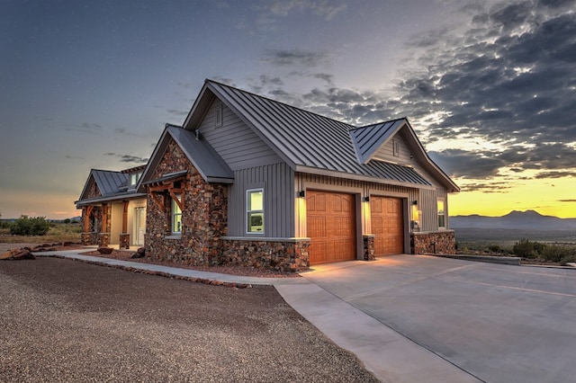 property exterior at dusk featuring a mountain view and a garage