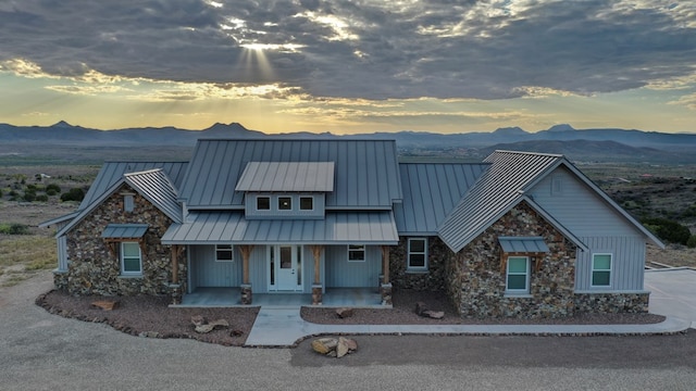 view of front of home with a mountain view and covered porch