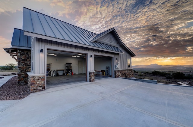 property exterior at dusk with a mountain view and a garage