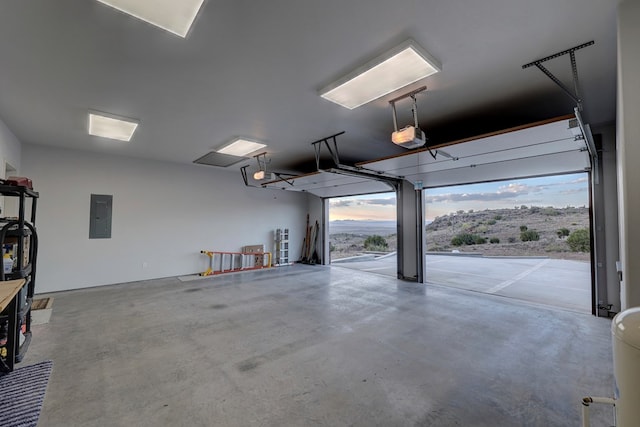 garage with electric panel and a garage door opener