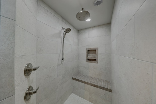 bathroom with a tile shower