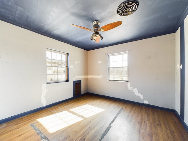 unfurnished room featuring hardwood / wood-style flooring, ornamental molding, and ceiling fan