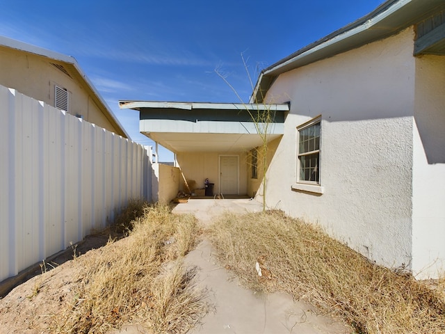 view of side of property featuring a patio