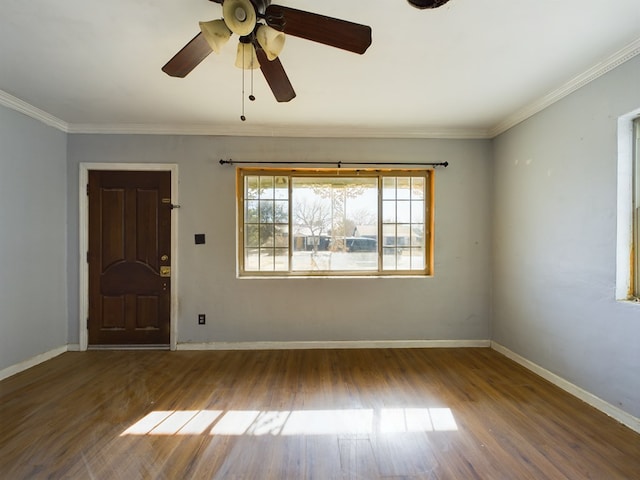 empty room featuring ornamental molding and dark hardwood / wood-style floors