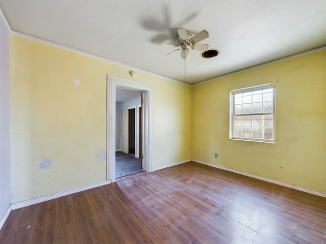 spare room featuring hardwood / wood-style floors and crown molding