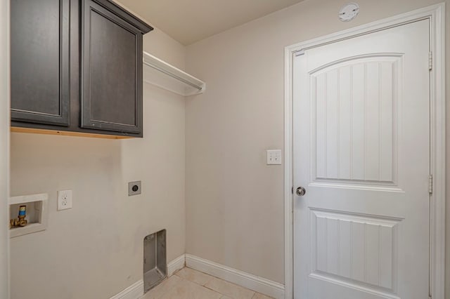 clothes washing area featuring washer hookup, electric dryer hookup, cabinets, and light tile patterned floors