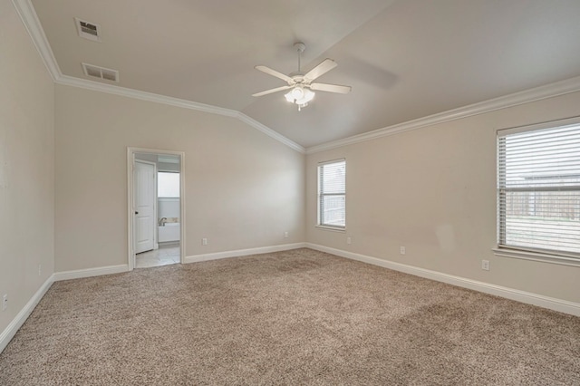 unfurnished room with vaulted ceiling, light carpet, crown molding, and visible vents