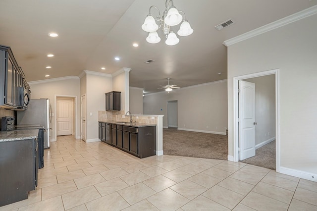 kitchen with ornamental molding, ceiling fan with notable chandelier, dark brown cabinetry, sink, and lofted ceiling