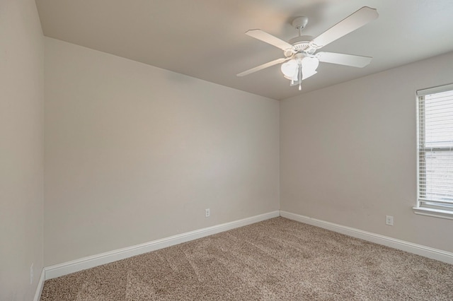 empty room with light colored carpet, ceiling fan, and baseboards