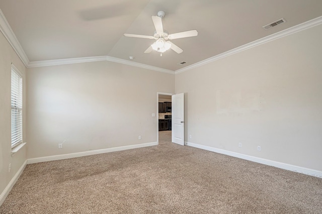 empty room featuring carpet flooring, ornamental molding, ceiling fan, and lofted ceiling