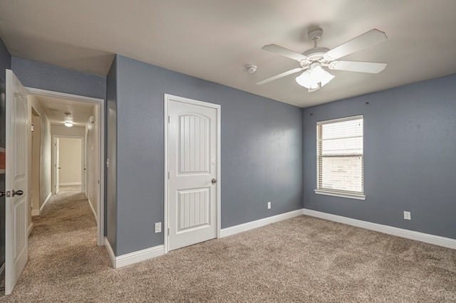 unfurnished bedroom featuring carpet floors, a closet, a ceiling fan, and baseboards