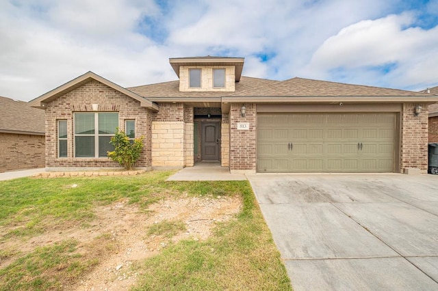 view of front of property with brick siding, roof with shingles, concrete driveway, a front yard, and a garage