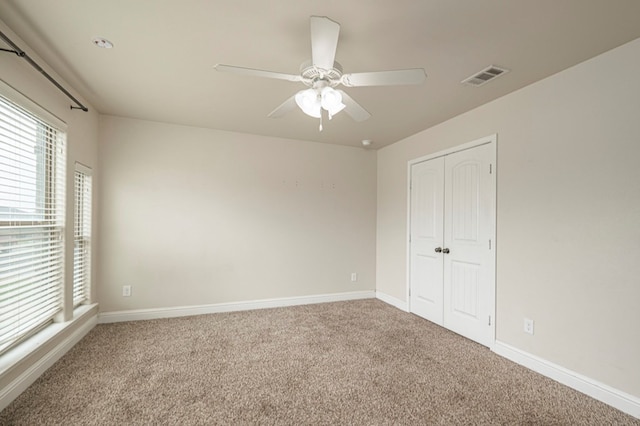 carpeted empty room with ceiling fan