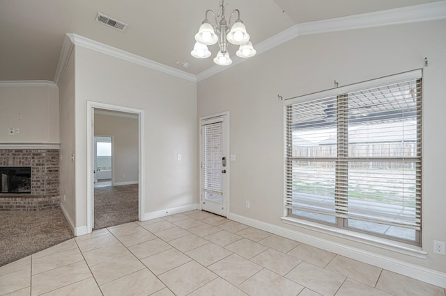 interior space with visible vents, crown molding, a brick fireplace, a wealth of natural light, and light tile patterned flooring