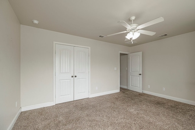 unfurnished bedroom featuring carpet floors, a closet, visible vents, ceiling fan, and baseboards