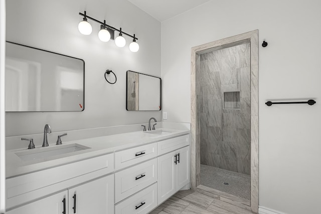 bathroom with vanity and tiled shower