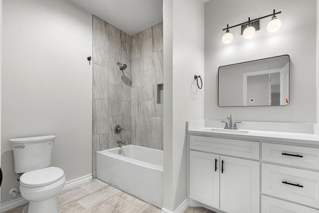 full bathroom featuring vanity, tiled shower / bath combo, and toilet