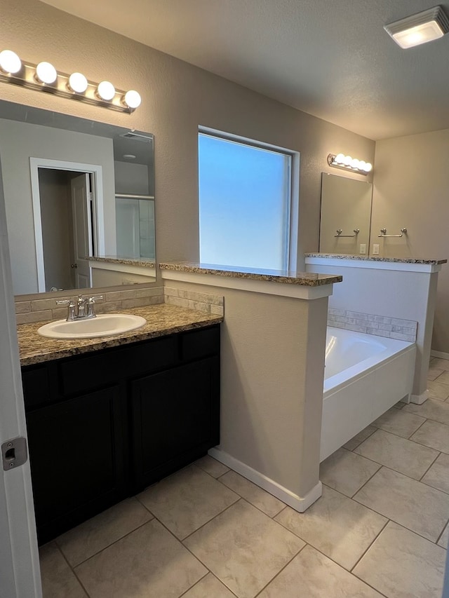 bathroom with tile patterned floors, vanity, separate shower and tub, and a textured ceiling