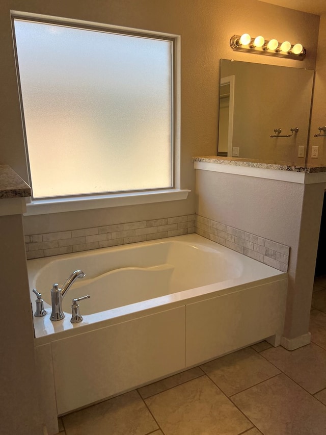 bathroom featuring tile patterned floors and a bathing tub