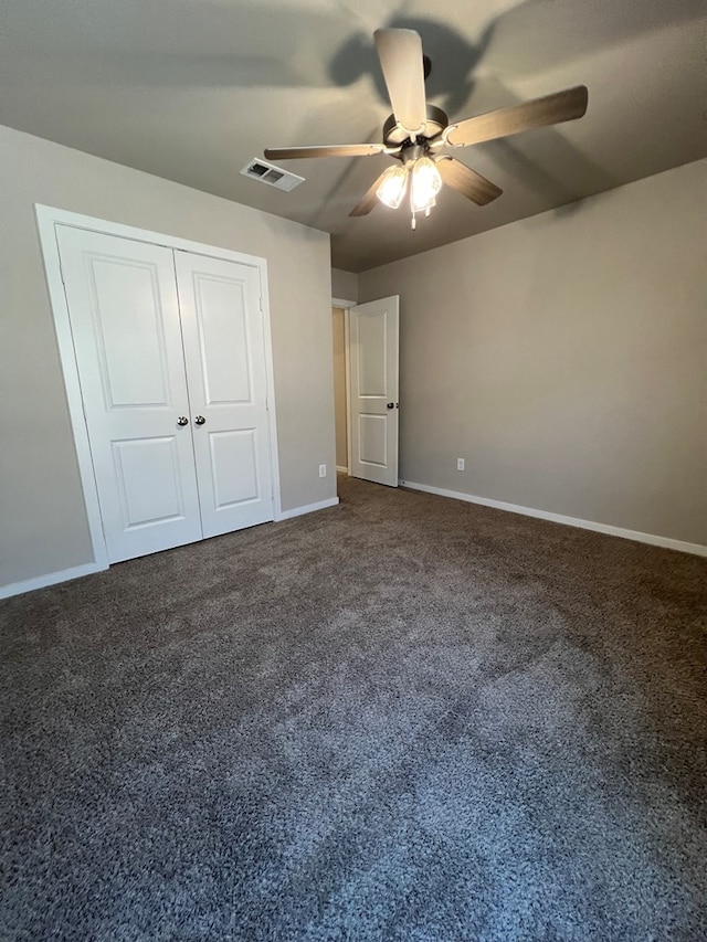 unfurnished bedroom featuring carpet floors, a closet, and ceiling fan