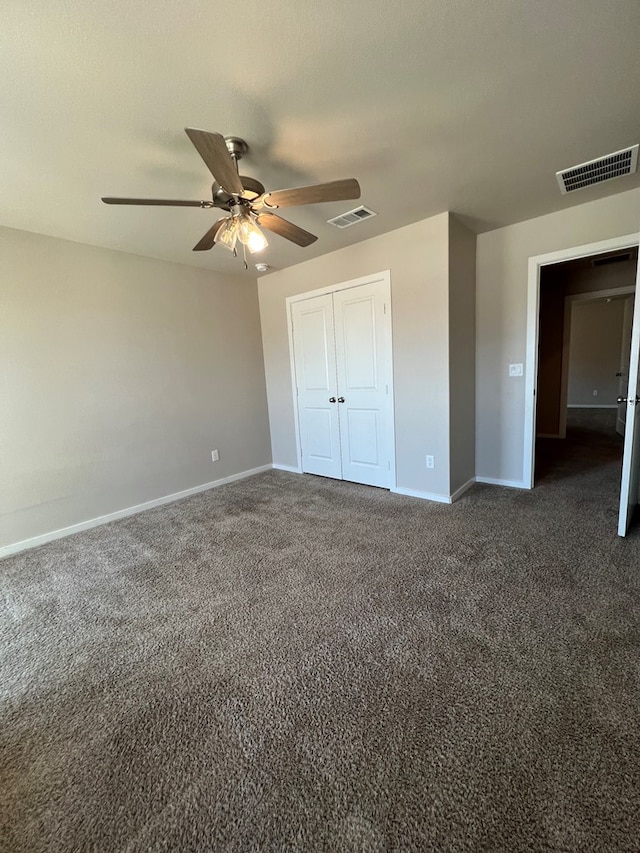 unfurnished bedroom featuring a closet, dark carpet, and ceiling fan