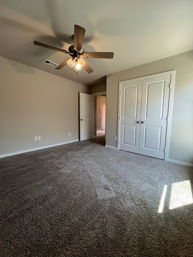 unfurnished bedroom with carpet flooring, ceiling fan, and a closet