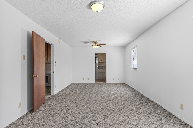 carpeted empty room featuring a textured ceiling and ceiling fan