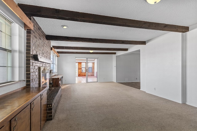 unfurnished living room featuring carpet floors, a brick fireplace, and a healthy amount of sunlight