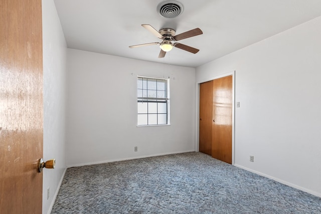 spare room featuring carpet flooring and ceiling fan