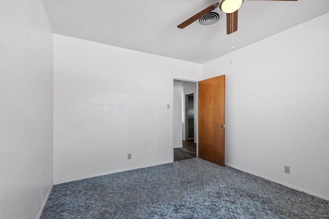 unfurnished room with dark colored carpet and ceiling fan