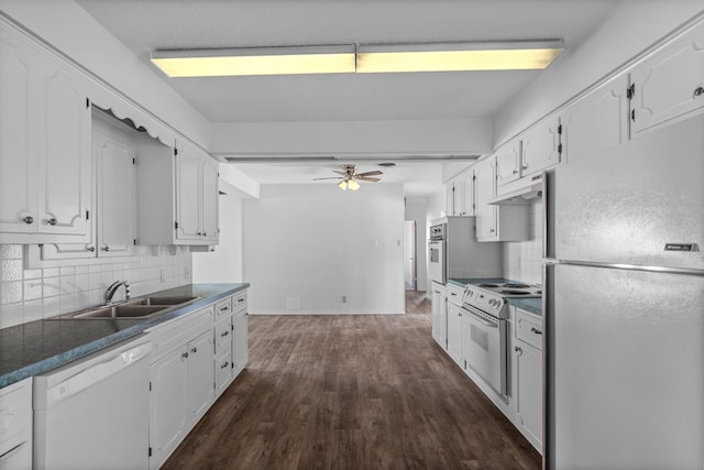 kitchen featuring white appliances, backsplash, dark wood-type flooring, white cabinets, and sink