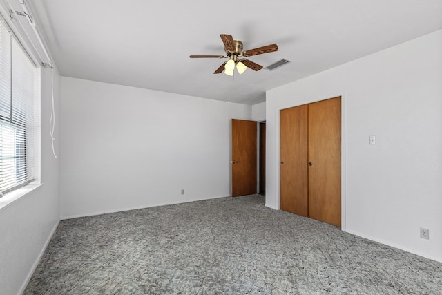 unfurnished bedroom featuring carpet flooring, ceiling fan, and a closet