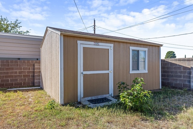 view of outbuilding with a yard