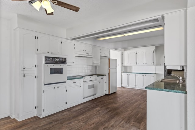 kitchen featuring white cabinetry, white appliances, sink, and dark wood-type flooring