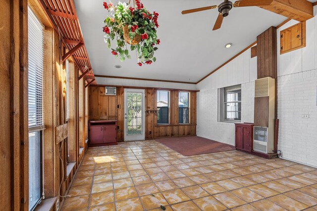 foyer entrance featuring ceiling fan, light tile patterned floors, crown molding, and brick wall