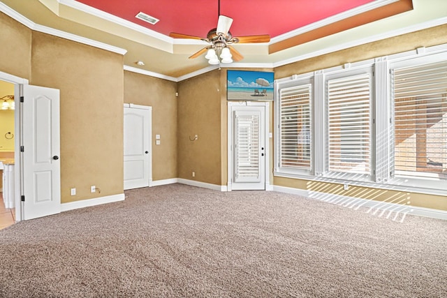 unfurnished bedroom featuring crown molding, carpet, and a raised ceiling