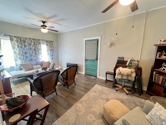 living room with ceiling fan, ornamental molding, and dark wood-type flooring