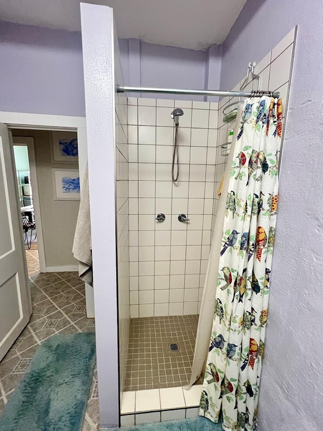 bathroom with tile patterned floors and a shower with shower curtain