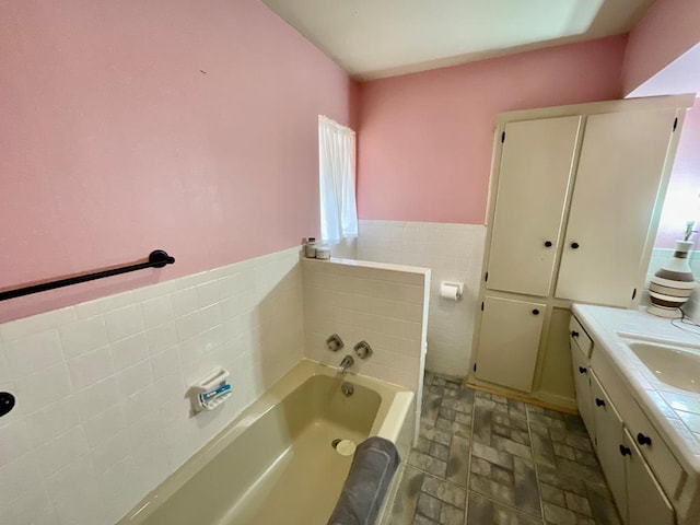 bathroom featuring a tub to relax in and vanity