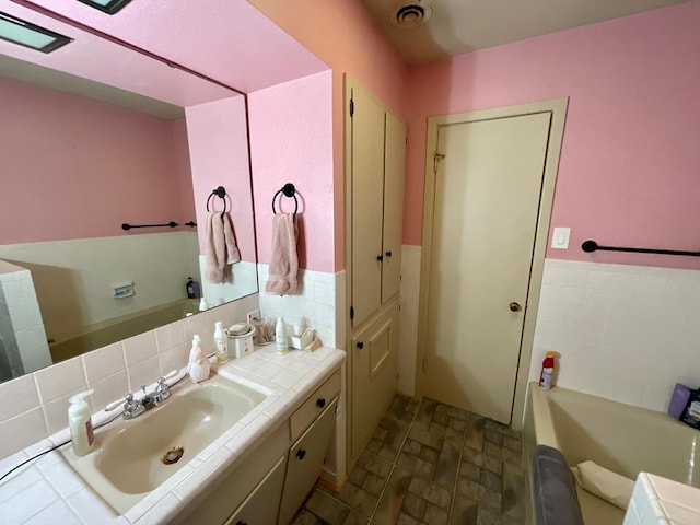 bathroom with vanity and a bathing tub