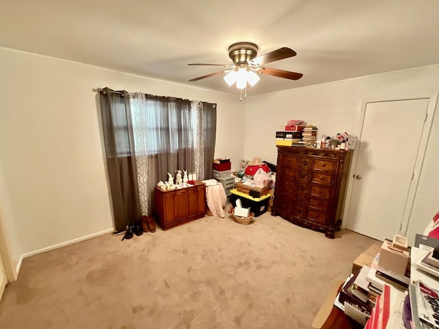 misc room with light carpet and ceiling fan