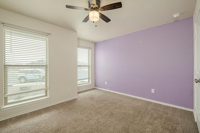 carpeted empty room featuring ceiling fan