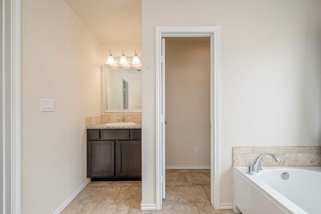 bathroom featuring vanity, a tub to relax in, and tile patterned floors