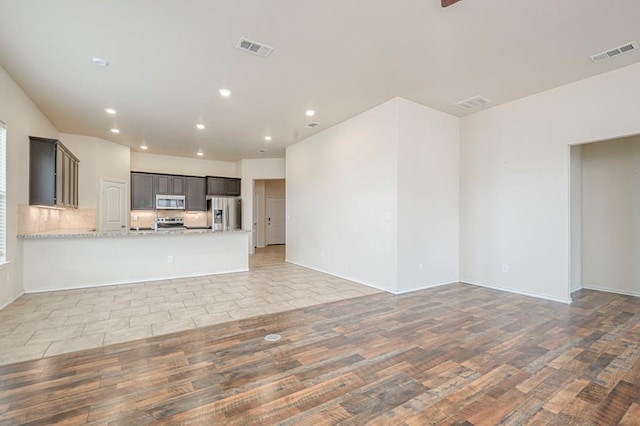 unfurnished living room with light hardwood / wood-style flooring