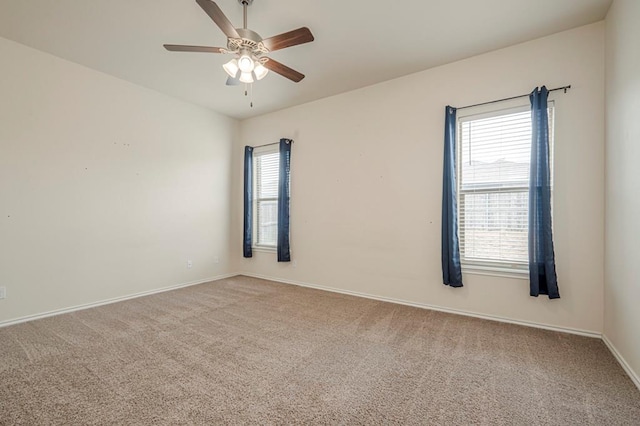 unfurnished room featuring ceiling fan, a healthy amount of sunlight, and carpet floors