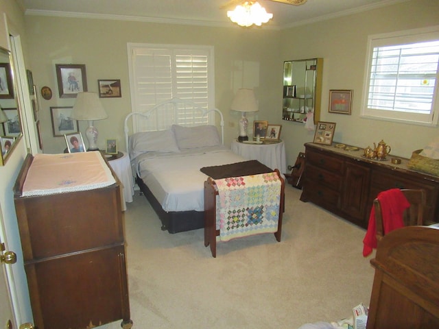 carpeted bedroom featuring ceiling fan and crown molding