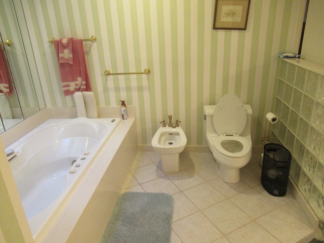 bathroom with toilet, a tub to relax in, tile patterned floors, and a bidet