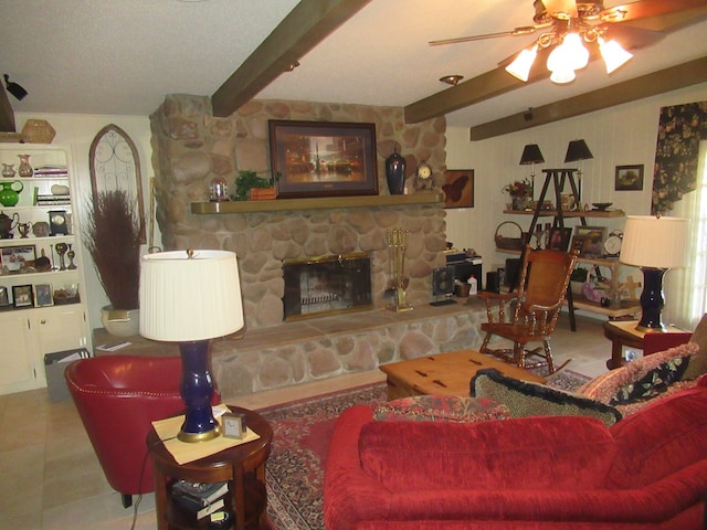 tiled living room with ceiling fan, a fireplace, and beamed ceiling