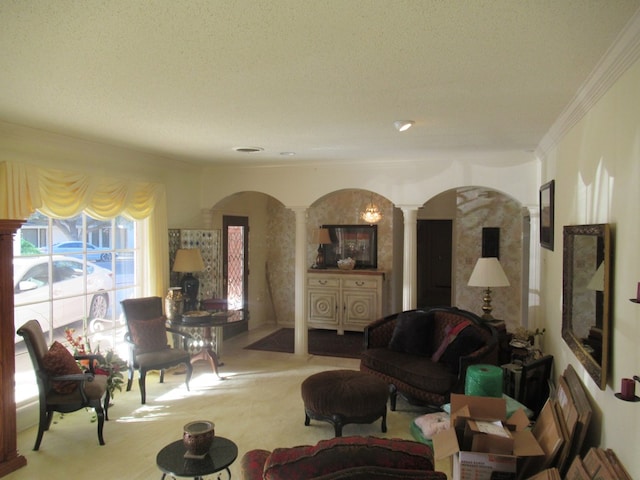 carpeted living room featuring decorative columns, crown molding, and a textured ceiling