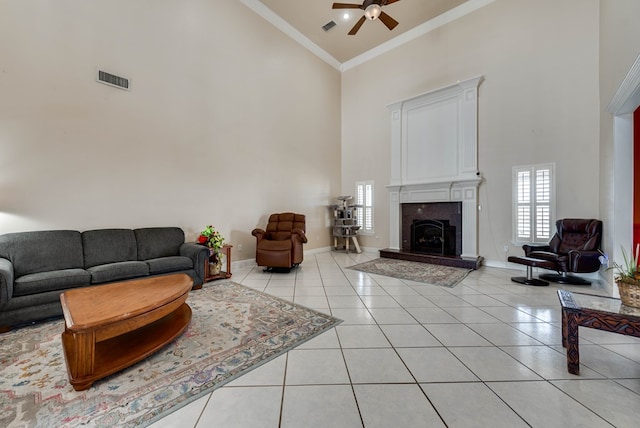 living room with ceiling fan, crown molding, high vaulted ceiling, and light tile patterned floors